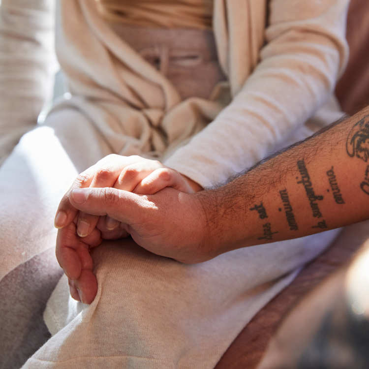 Clients holding hands in clinic